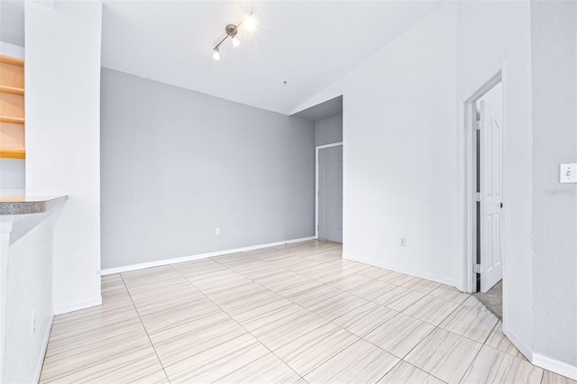 spare room featuring lofted ceiling