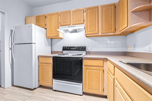 kitchen with electric range oven, light brown cabinets, backsplash, and white refrigerator