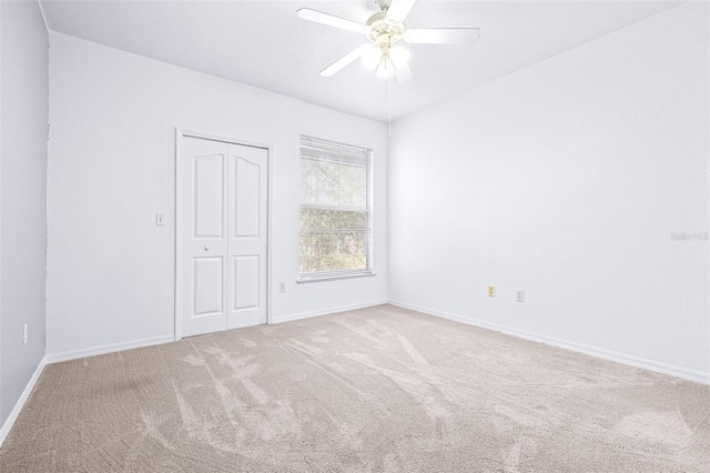 empty room featuring light carpet and ceiling fan