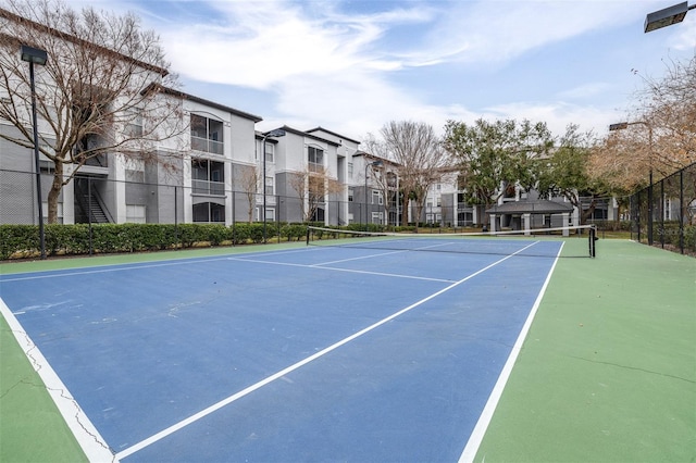 view of tennis court with basketball hoop