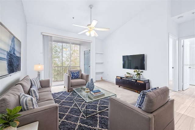 living room featuring ceiling fan and high vaulted ceiling