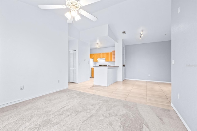 unfurnished living room with ceiling fan and light tile patterned floors