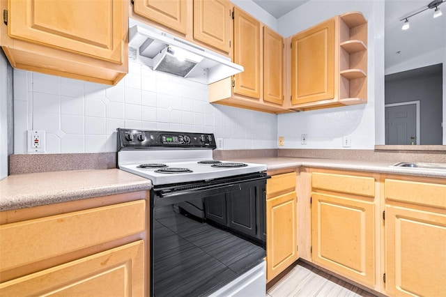 kitchen featuring tasteful backsplash, light brown cabinets, electric range, and sink