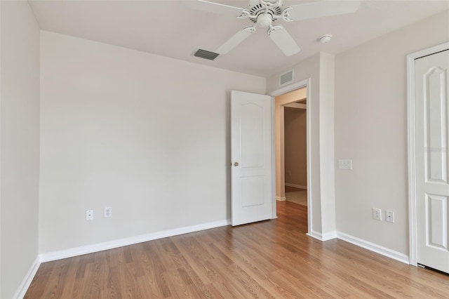 unfurnished bedroom with ceiling fan and light wood-type flooring