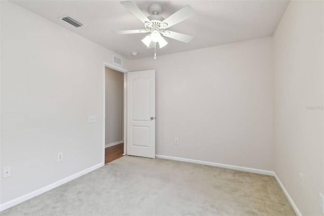 spare room with light carpet and ceiling fan