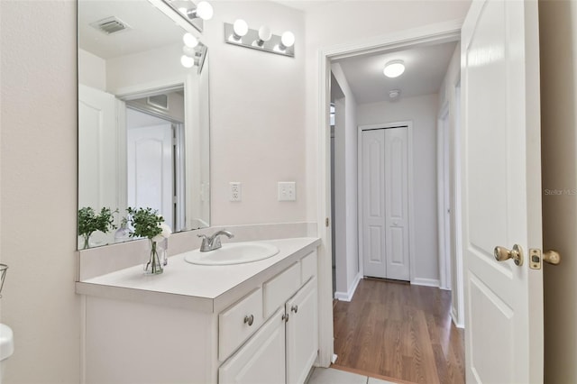 bathroom with vanity and hardwood / wood-style floors