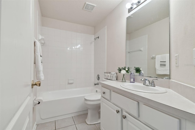 full bathroom featuring tile patterned flooring, vanity, tiled shower / bath combo, and toilet