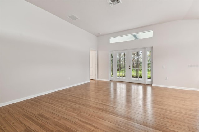 empty room featuring light hardwood / wood-style floors and french doors