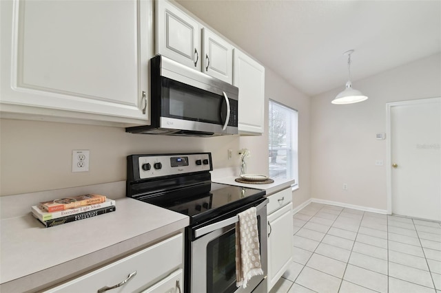 kitchen with white cabinetry, appliances with stainless steel finishes, pendant lighting, and light tile patterned floors