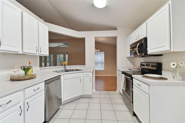 kitchen featuring white cabinetry, vaulted ceiling, and appliances with stainless steel finishes