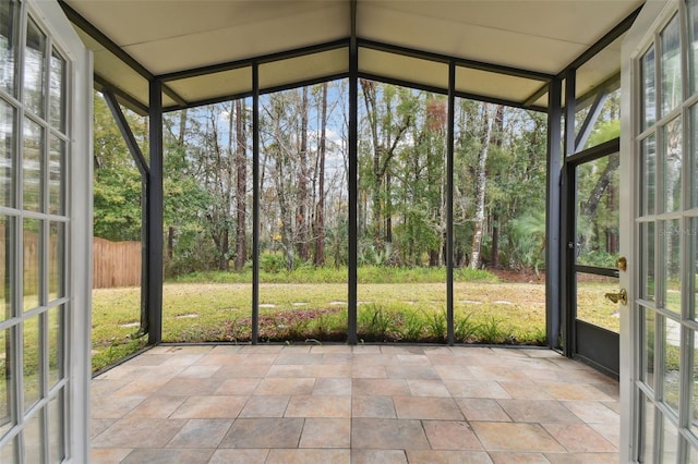 unfurnished sunroom featuring vaulted ceiling