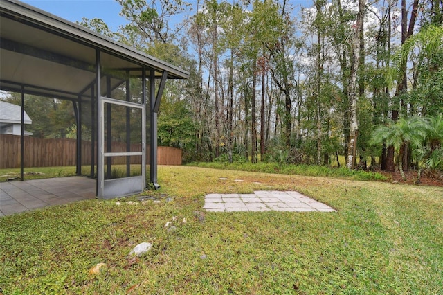 view of yard featuring a sunroom and a patio