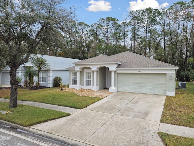 ranch-style house with a garage, a front yard, and cooling unit