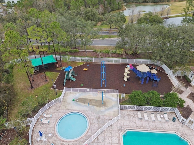 view of swimming pool featuring a playground and a patio area