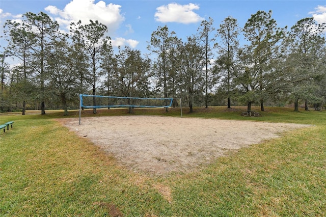 surrounding community featuring volleyball court and a lawn