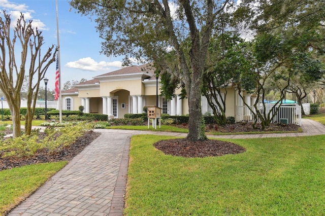 mediterranean / spanish home with a front lawn