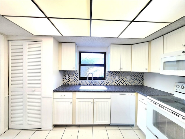 kitchen featuring backsplash, sink, white appliances, and white cabinets