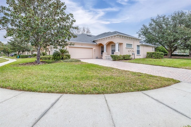 view of front of property with a front lawn and a garage