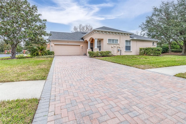 view of front of house featuring a garage and a front lawn