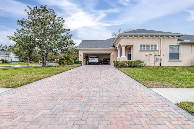 view of front of home with a front yard and a garage