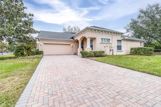 view of front of home with a front lawn and a garage