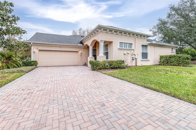 view of front facade with a garage and a front lawn