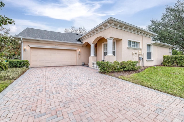 view of front of property featuring a garage and a front lawn