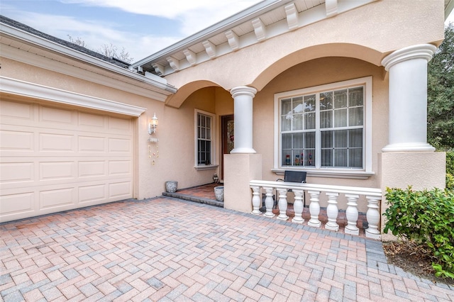 doorway to property with a garage