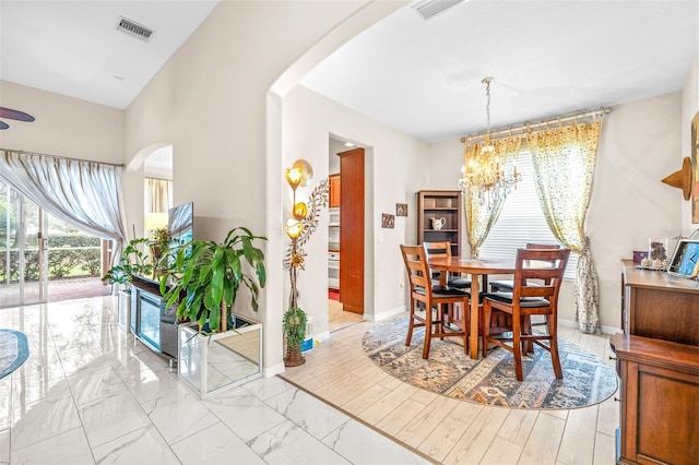 dining space with a healthy amount of sunlight and a chandelier