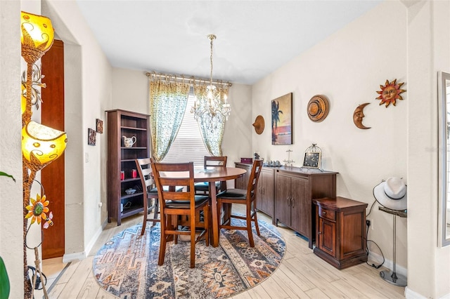 dining area featuring a chandelier and light hardwood / wood-style floors