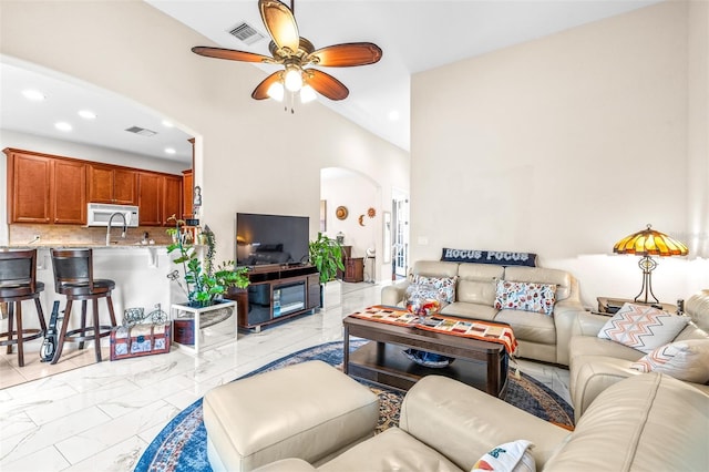 living room with vaulted ceiling and ceiling fan