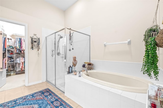 bathroom with separate shower and tub and tile patterned flooring