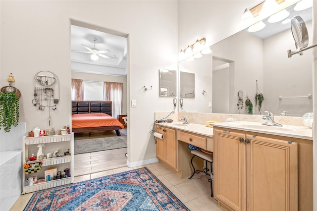 bathroom featuring ceiling fan, tile patterned floors, vanity, and a bathing tub