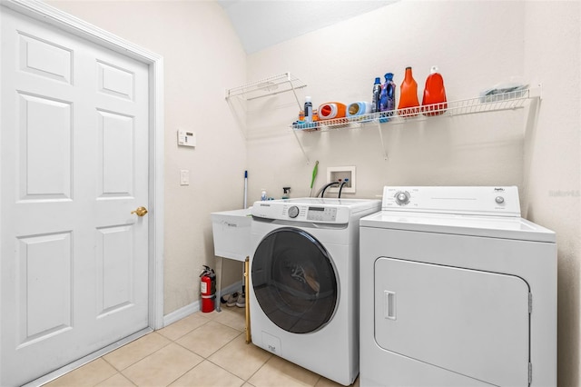 washroom featuring light tile patterned floors and washer and dryer