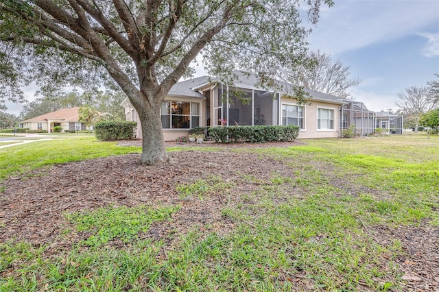 ranch-style house featuring a front lawn and a sunroom