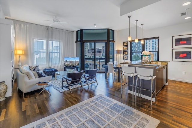 living room with ceiling fan, dark wood-type flooring, and floor to ceiling windows