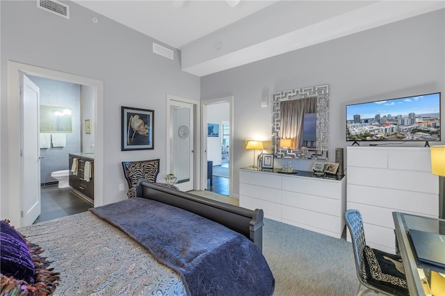 bedroom featuring ceiling fan and connected bathroom