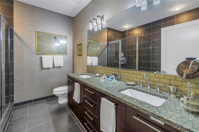 bathroom featuring toilet, a shower with door, tasteful backsplash, tile patterned floors, and vanity