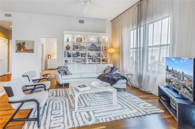 living room with ceiling fan and dark hardwood / wood-style floors