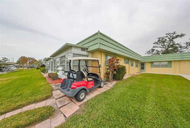 view of side of property with a yard