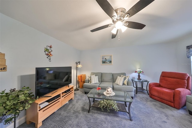 living room featuring ceiling fan and dark colored carpet