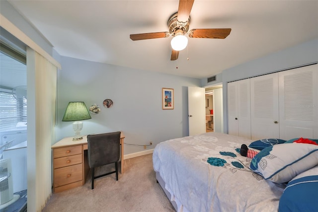 bedroom with ceiling fan, a closet, and light carpet