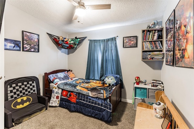 carpeted bedroom featuring a textured ceiling and ceiling fan