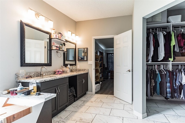 bathroom with vanity and a textured ceiling