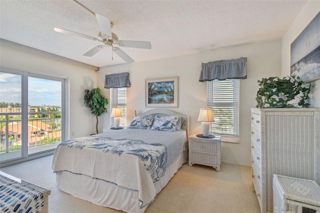 carpeted bedroom with a textured ceiling and ceiling fan