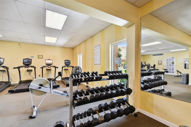 exercise room featuring a drop ceiling