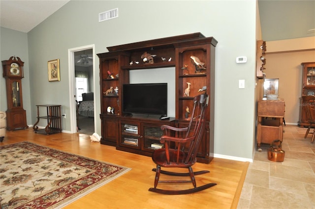 living room with hardwood / wood-style floors and lofted ceiling