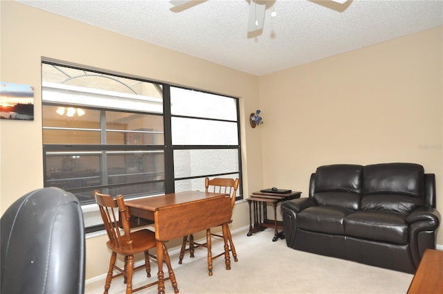 living room with light colored carpet, a textured ceiling, and ceiling fan