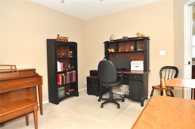 carpeted home office featuring a textured ceiling