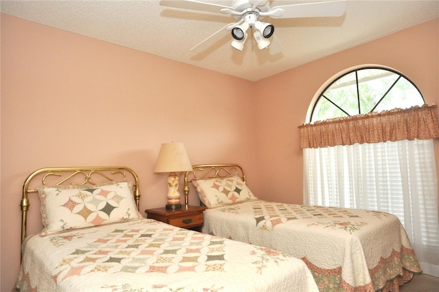 bedroom featuring a textured ceiling and ceiling fan